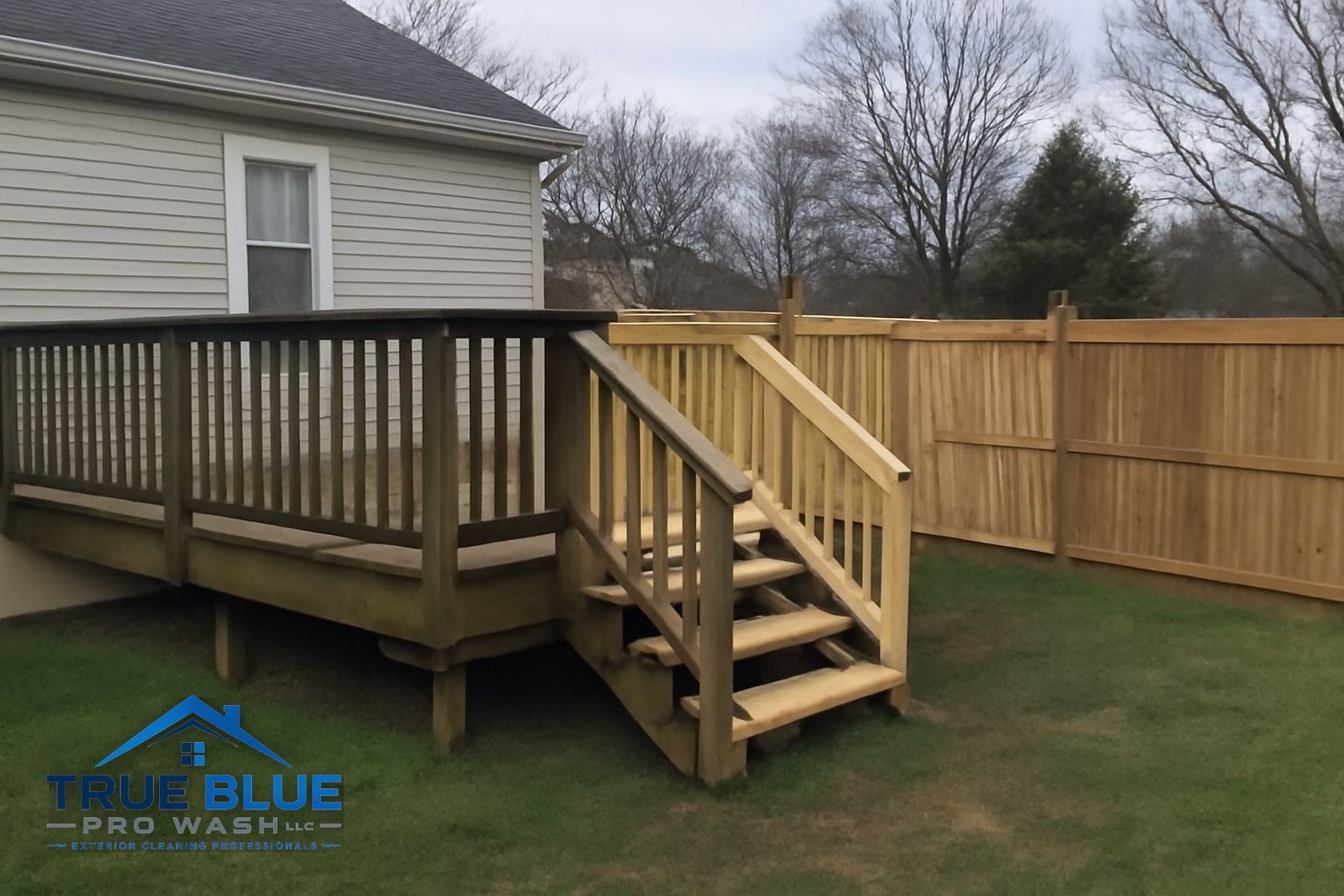 Wood deck covered in green algae and gray oxidation before soft washing in Penns Grove NJ