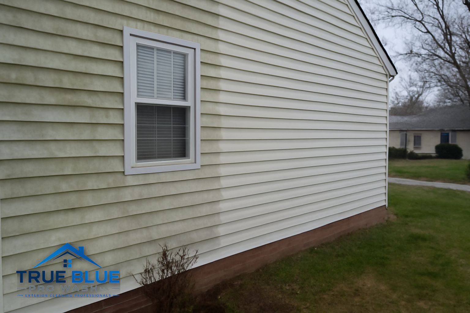 Technician applying soft wash solution to the siding of a home in Newark Delaware
