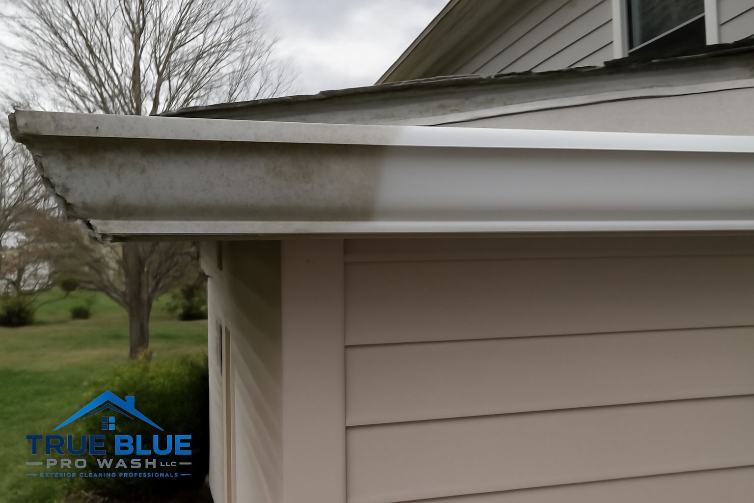 Flushing a downspout on a Greenville Delaware home after gutter cleaning