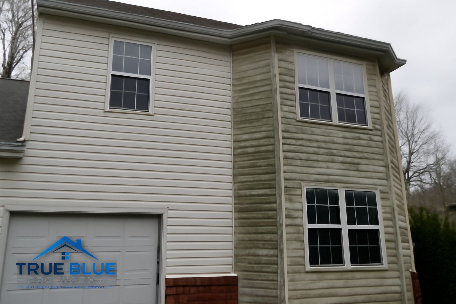 True Blue Pro Wash technician soft washing a two-story home exterior in Chester County Pennsylvania