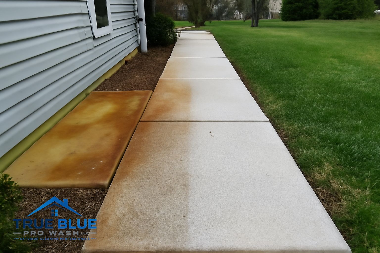 Orange rust stains on a concrete driveway in Kennett Square PA before treatment