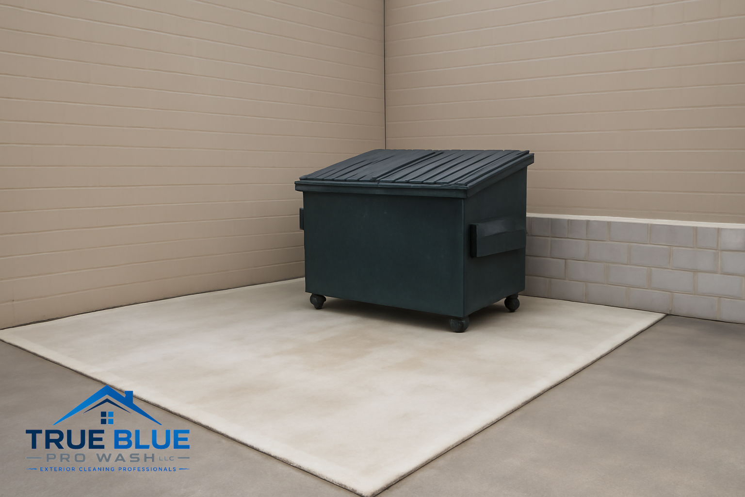 Clean concrete dumpster pad at a commercial property, with a metal dumpster and low wall.